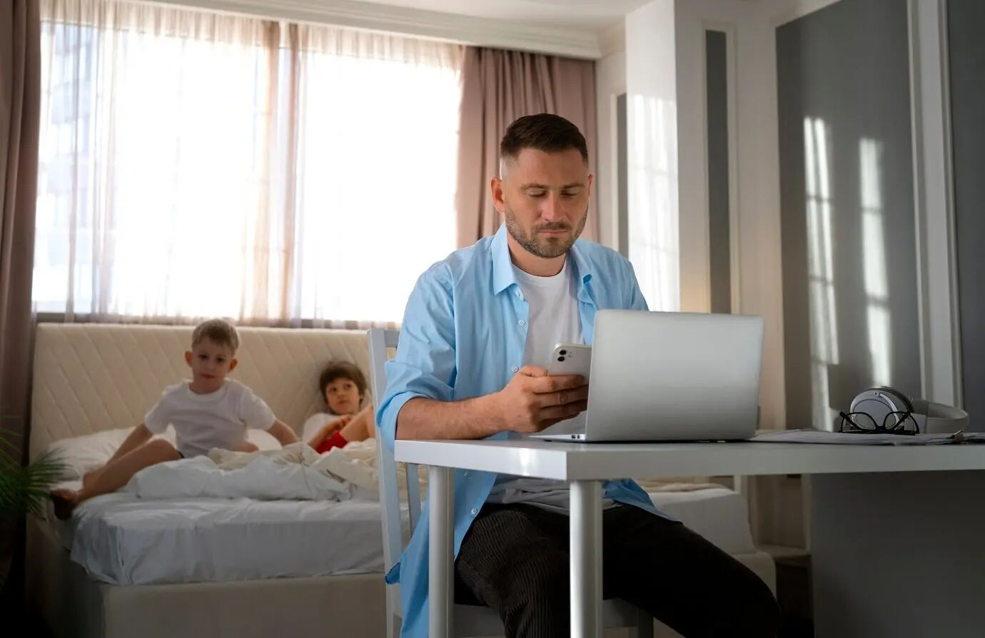 A father working from home, trying to balance work and family life with a child.