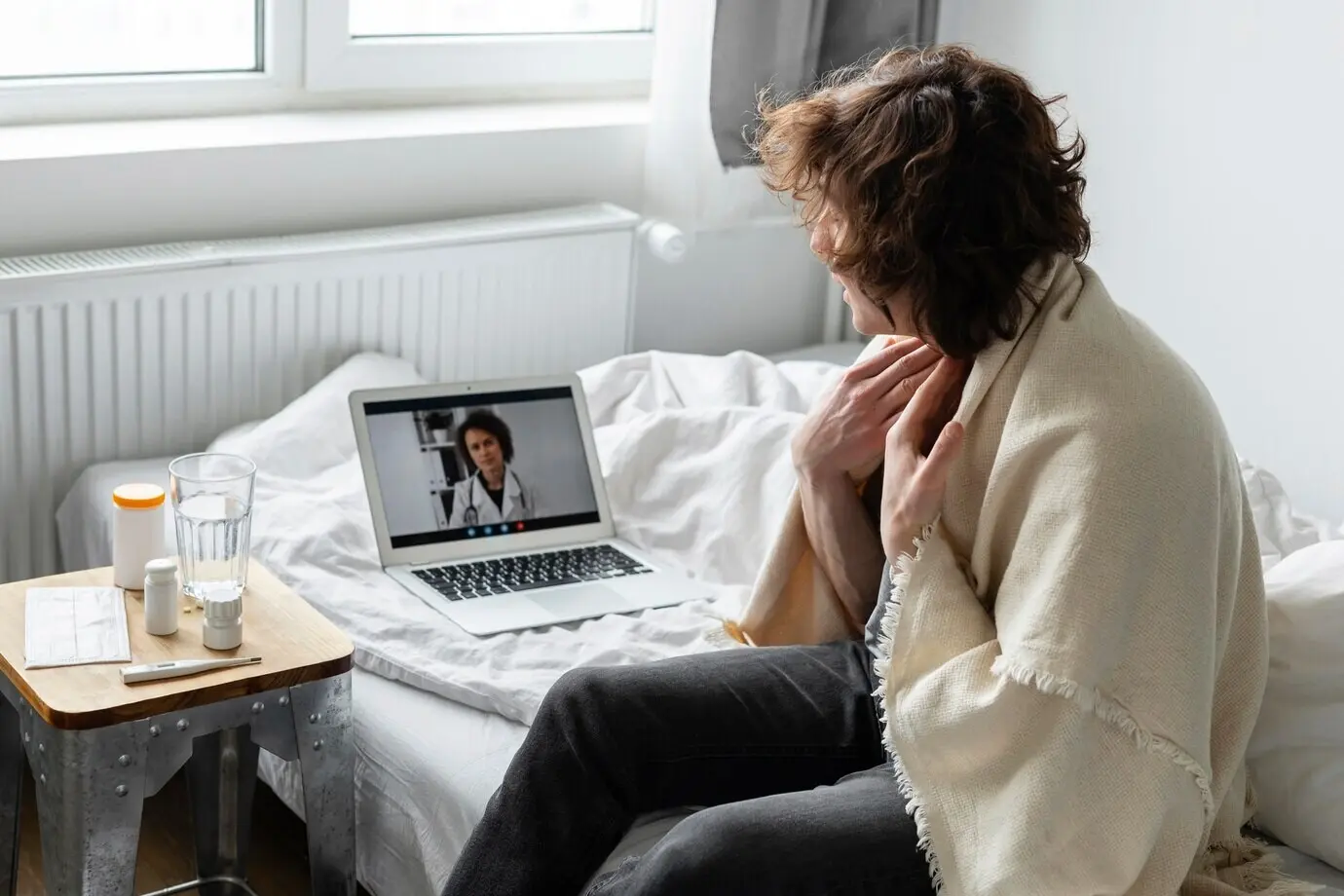 A sick man is on a video call with a doctor.